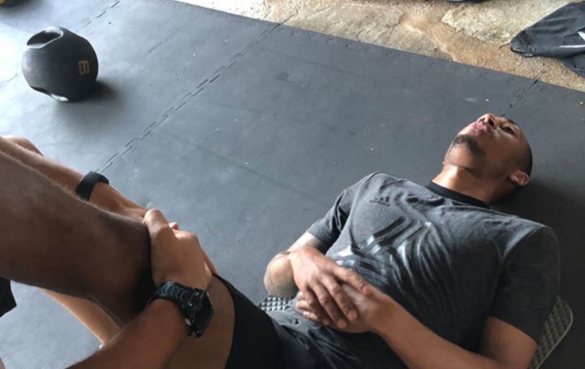 A physiotherapist treating a patient's hip on a treatment couch in the MY Sports Injury clinic.
