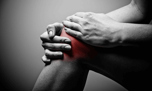 Hands holding a knee with the joint highlighted in red